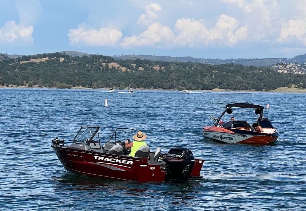 Bass boat and a wakeboard boat on Folsom Lake, California